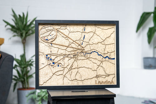 Framed personalised wooden map wall art displayed in a home interior